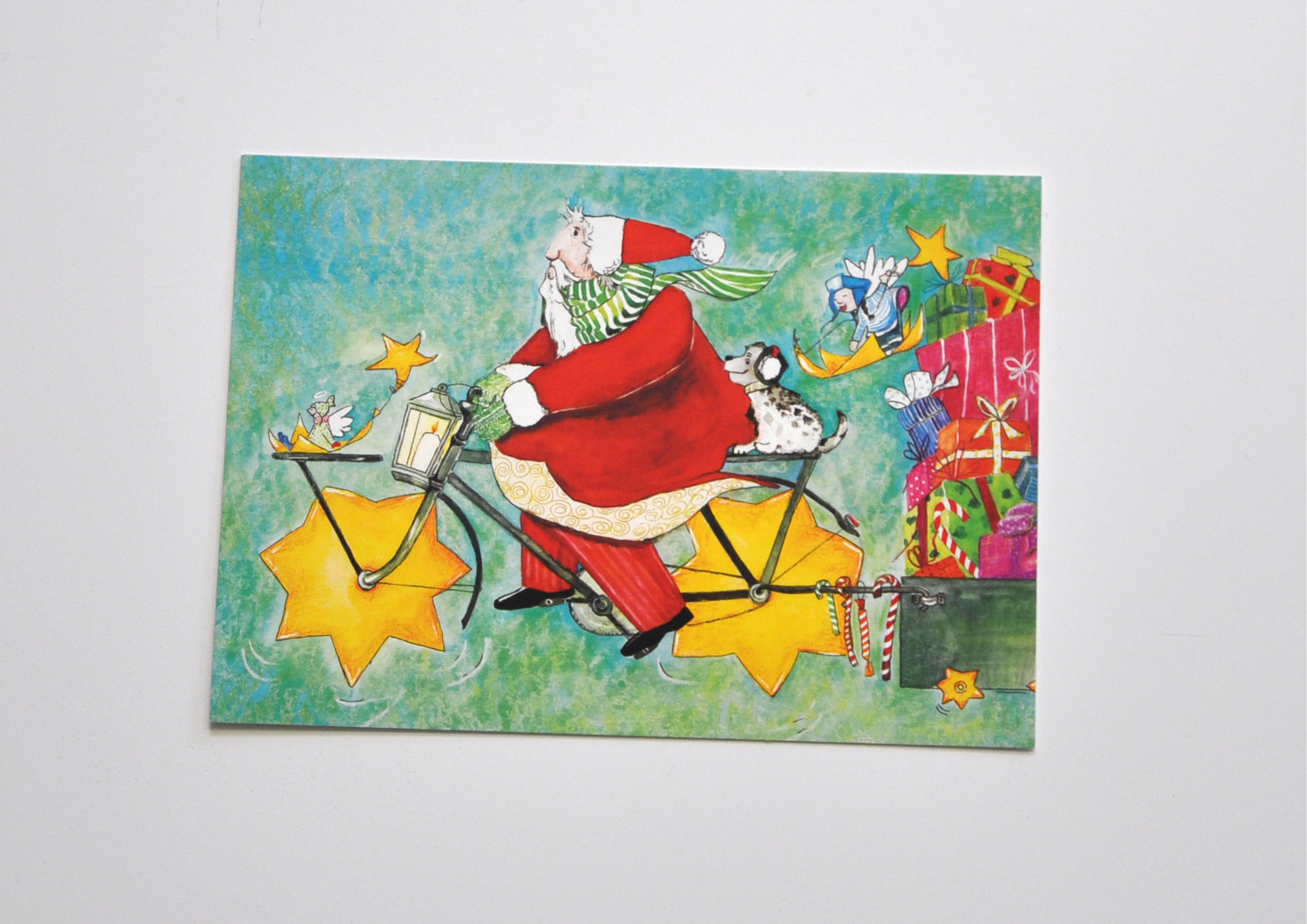 Weihnachtsmann mit Sternenfahrrad - Postkarte 